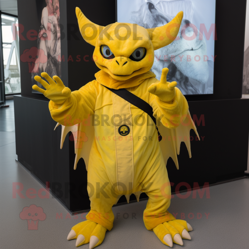 Yellow Gargoyle mascot costume character dressed with a Cover-up and Mittens