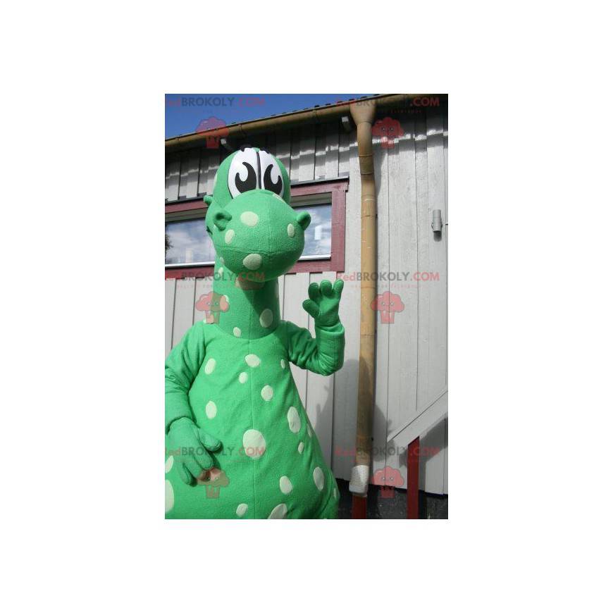 Mascote dragão dinossauro verde com pontos brancos -