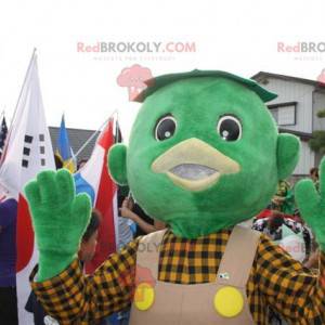 Mascota de muñeco de nieve verde con un mono y una camisa -