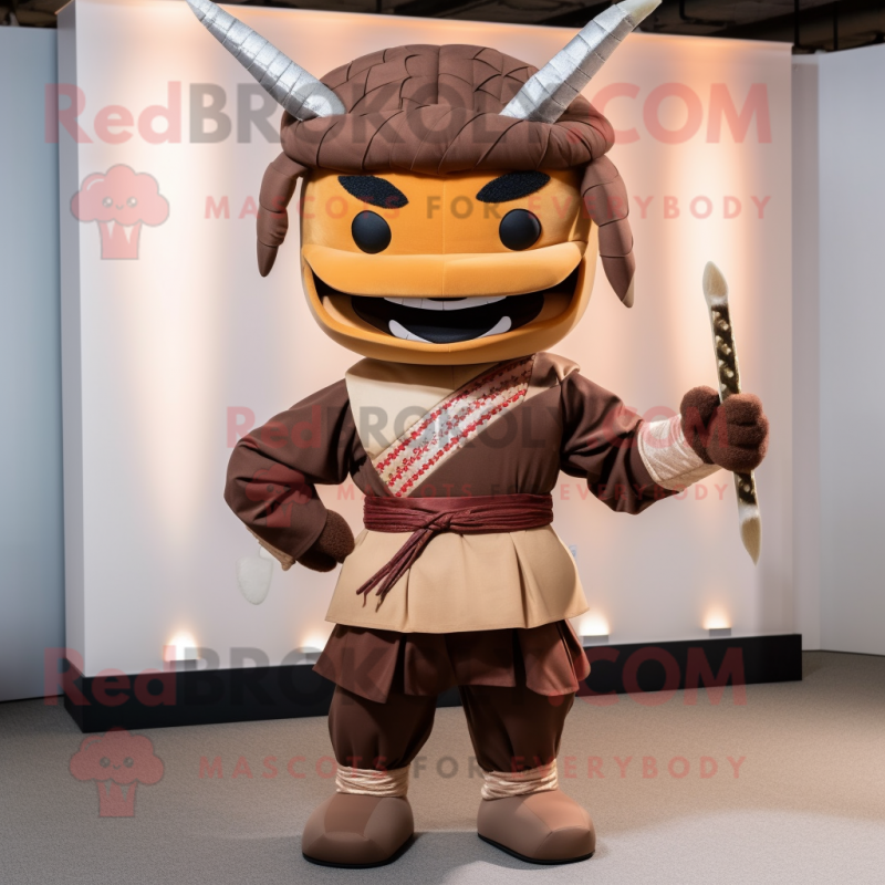 Brown Samurai mascot costume character dressed with a Trousers and Bow ties Brown Samurai mascot costume character dressed with a Trousers and Bow ties