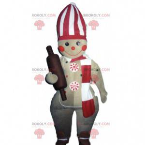 Mascotte de bonhomme pain d'épice avec un rouleau à pâtisserie