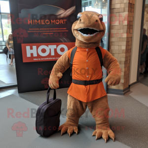 Rust Komodo Dragon mascot costume character dressed with a Romper and Messenger bags