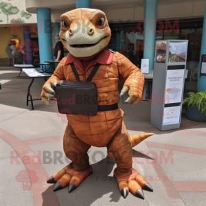 Rust Komodo Dragon mascot costume character dressed with a Romper and Messenger bags