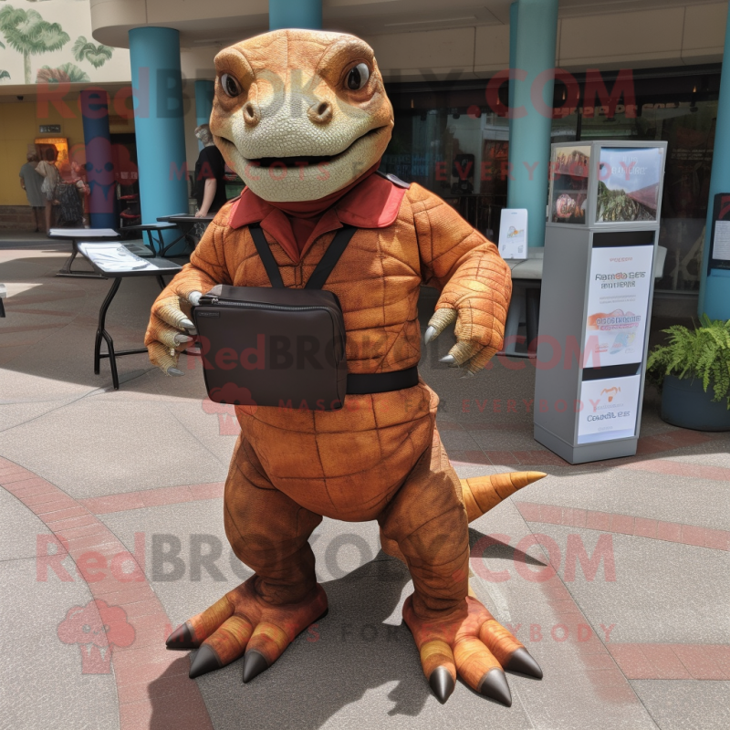 Rust Komodo Dragon mascot costume character dressed with a Romper and Messenger bags Rust Komodo Dragon mascot costume character dressed with a Romper and Messenger bags