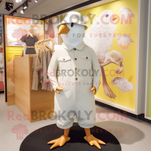 Cream Pigeon mascot costume character dressed with a Playsuit and Hats