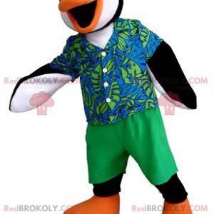 Mascote pinguim preto branco e laranja com uma roupa colorida -