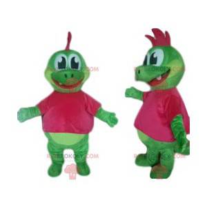 Mascotte dinosauro verde con un grazioso stemma fucsia -