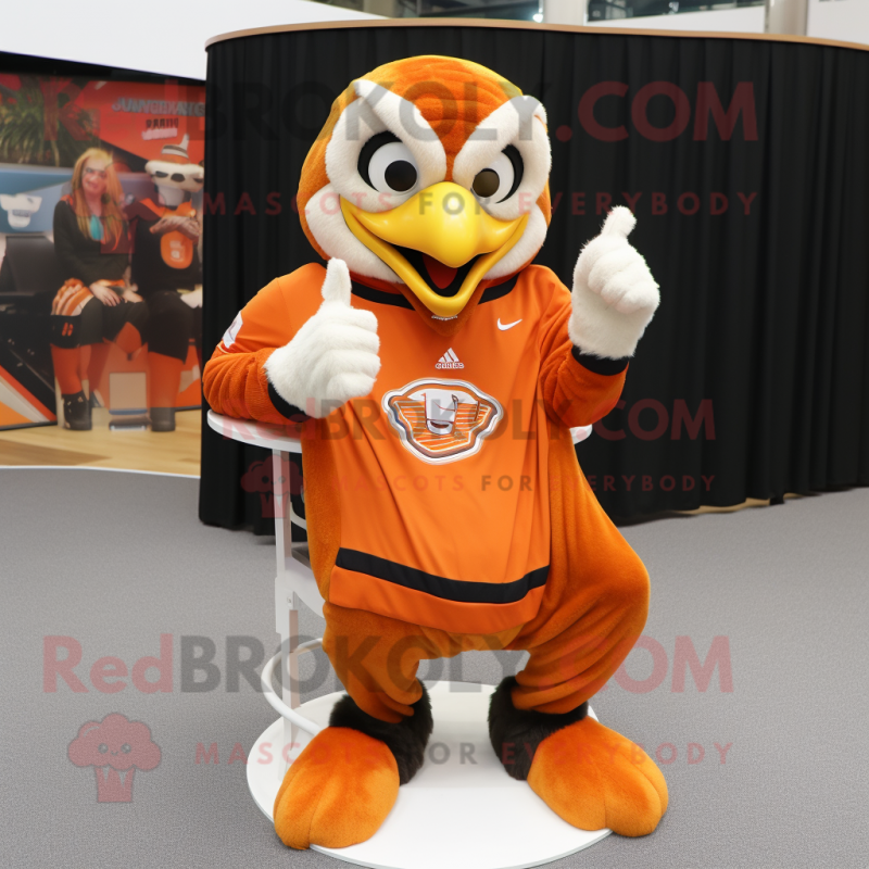 Orange Eagle mascot costume character dressed with a Sweater and Rings Orange Eagle mascot costume character dressed with a Sweater and Rings