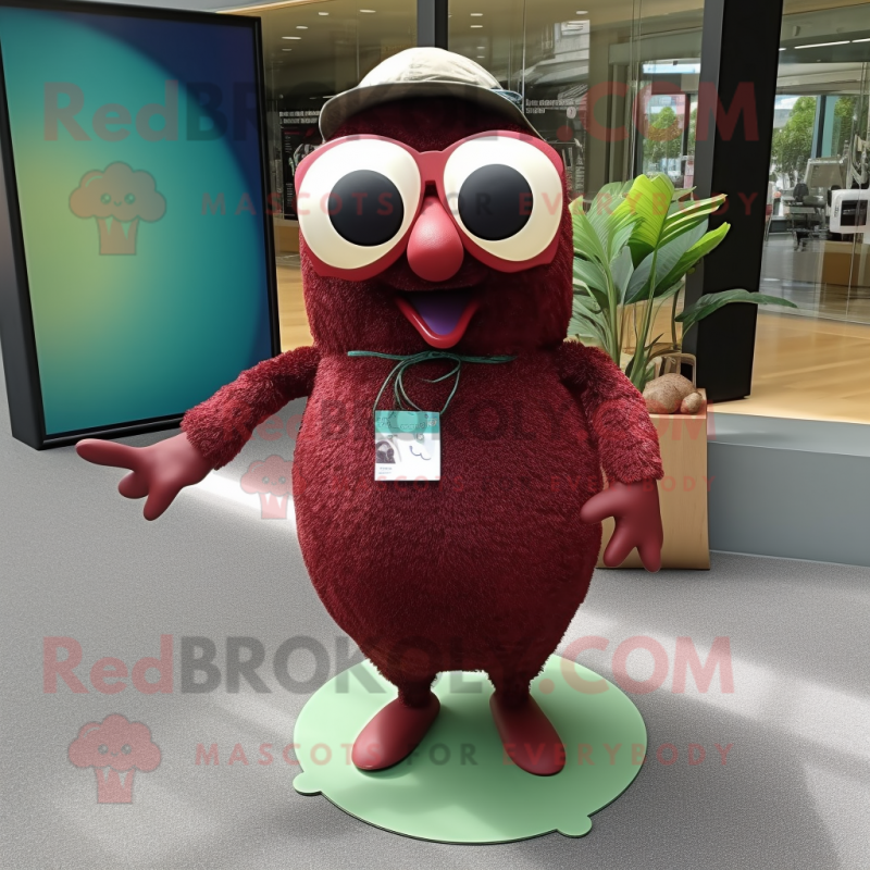 Maroon Kiwi mascot costume character dressed with a Shift Dress and Sunglasses Maroon Kiwi mascot costume character dressed with a Shift Dress and Sunglasses