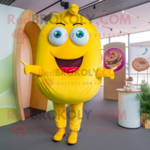 Lemon Yellow Donut mascot costume character dressed with a Jumpsuit and Hair clips