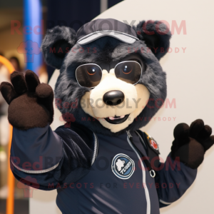 Navy Spectacled Bear mascot costume character dressed with a Graphic Tee and Mittens