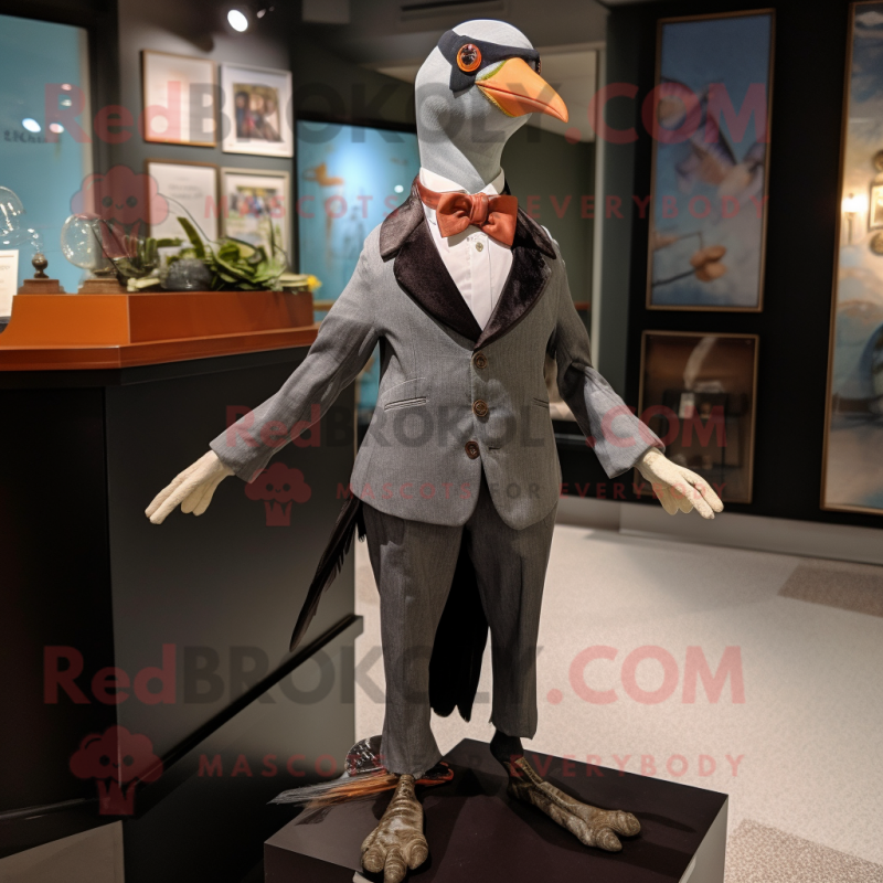 Gray Passenger Pigeon mascot costume character dressed with a Tuxedo and Suspenders