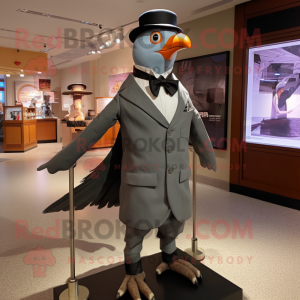 Gray Passenger Pigeon mascot costume character dressed with a Tuxedo and Suspenders