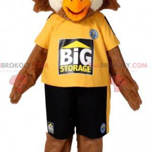 Brown eagle mascot in sportswear. Eagle costume - Redbrokoly.com