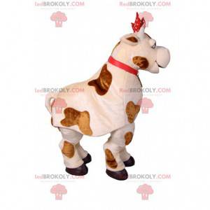 Cow mascot with a red polka dot node. Cow costume -