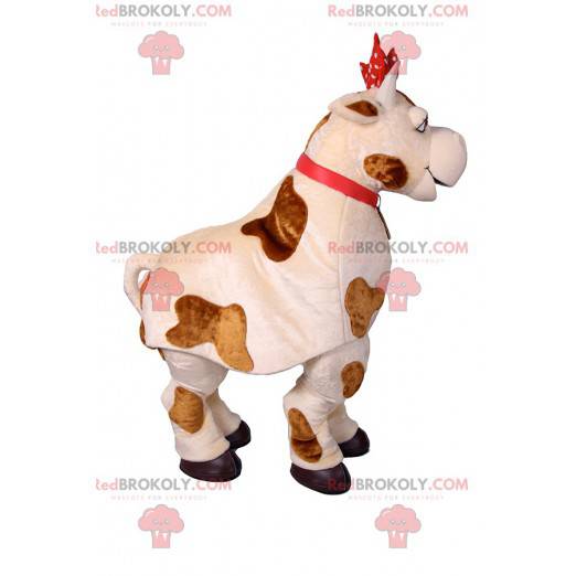 Mascotte della mucca con un nodo rosso a pois. Costume da mucca