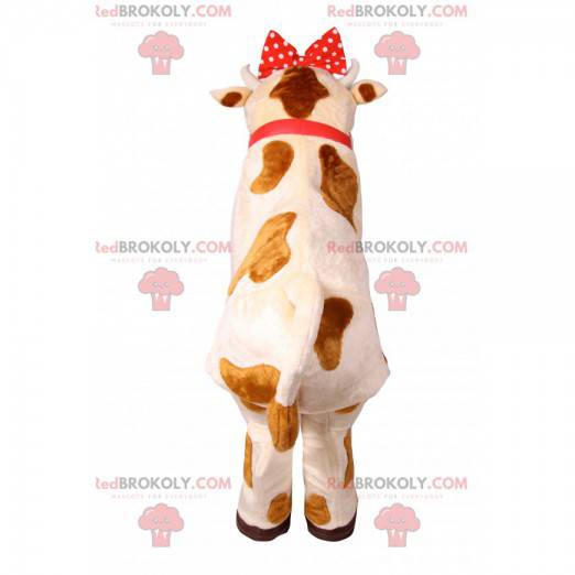 Cow mascot with a red polka dot node. Cow costume -