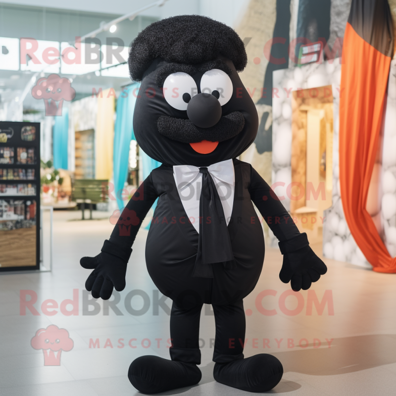 Black Moussaka mascot costume character dressed with a Romper and Bow ties Black Moussaka mascot costume character dressed with a Romper and Bow ties