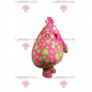 Mascotte de grosse goutte fushia avec des pois verts -