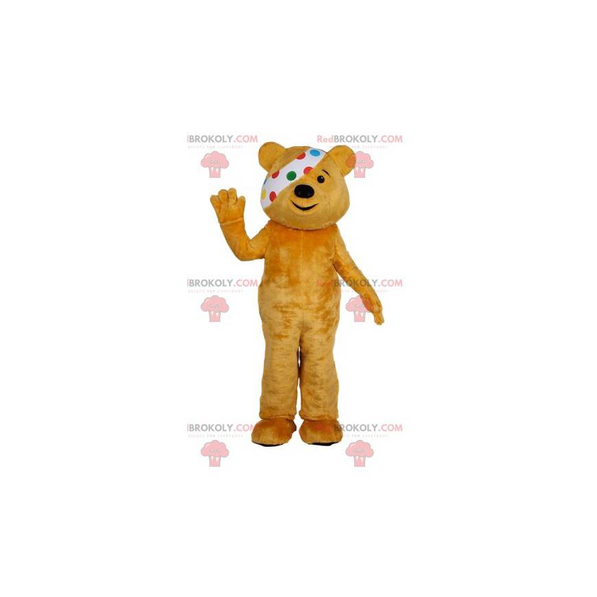 Gelbes Bärenmaskottchen mit einem Verband. Gelbes Bärenkostüm - Gelbes Bärenmaskottchen mit einem Verband. Gelbes Bärenkostüm -
