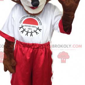 Mascotte bruine vos in rode en witte sportkleding -