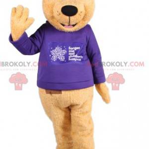 Mascotte d'ours brun avec un maillot bleu. Costume d'ours -