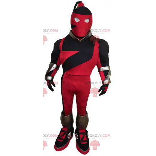 Mascota de superhéroe enmascarado en rojo y negro -