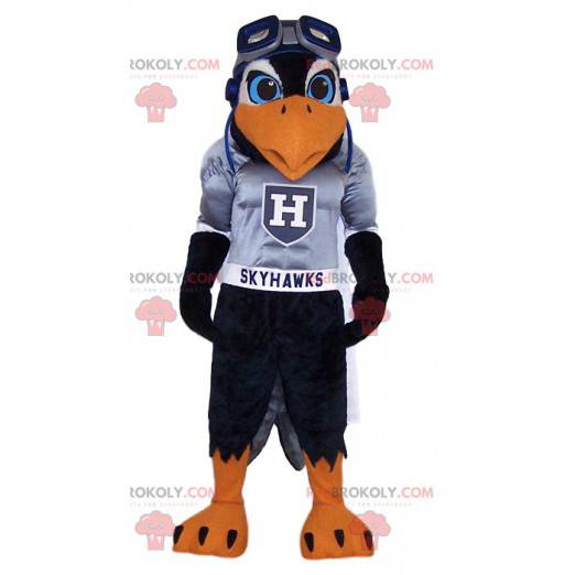 Mascotte d'aigle noir en maillot de supporter gris -