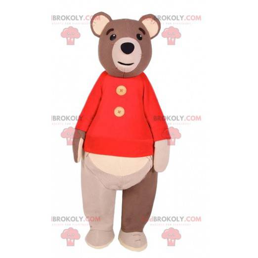 Mascote do urso pardo com um suéter vermelho. Fantasia de urso