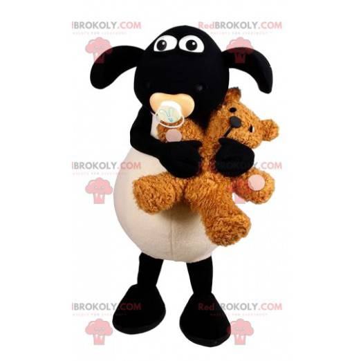Mascote ovelha branca e negra com um ursinho de pelúcia -