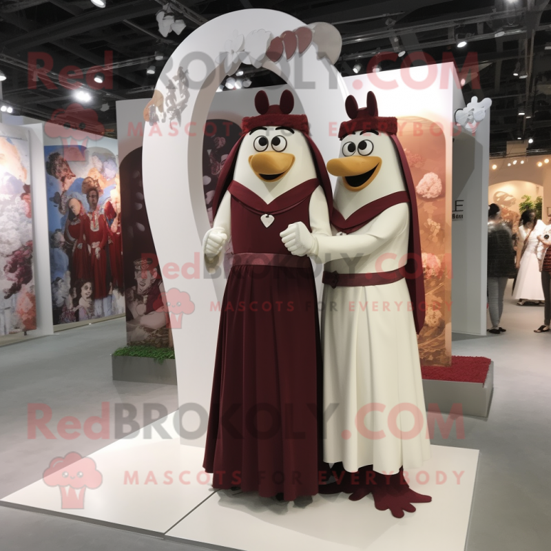 Maroon Arrow Of Love mascot costume character dressed with a Wedding Dress and Belts Maroon Arrow Of Love mascot costume character dressed with a Wedding Dress and Belts