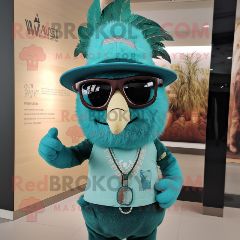 Teal Chief mascot costume character dressed with a V-Neck Tee and Eyeglasses Teal Chief mascot costume character dressed with a V-Neck Tee and Eyeglasses