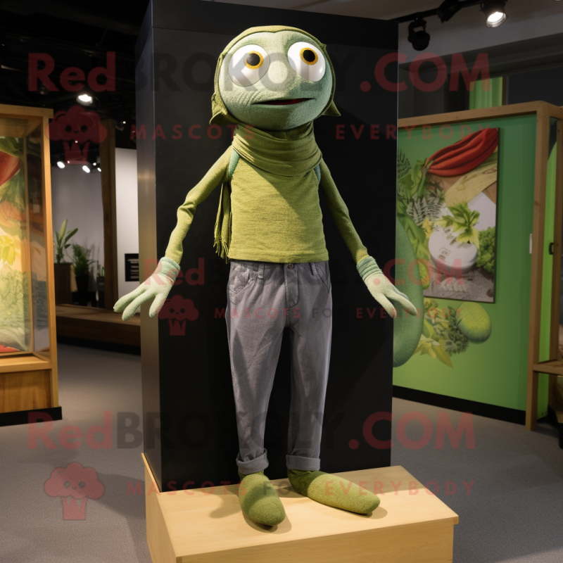 Olive Tightrope Walker mascot costume character dressed with a Jeans and Shawls Olive Tightrope Walker mascot costume character dressed with a Jeans and Shawls