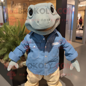 Tan Komodo Dragon mascot costume character dressed with a Chambray Shirt and Wraps