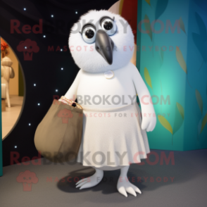 White Kiwi mascot costume character dressed with a Wrap Skirt and Clutch bags