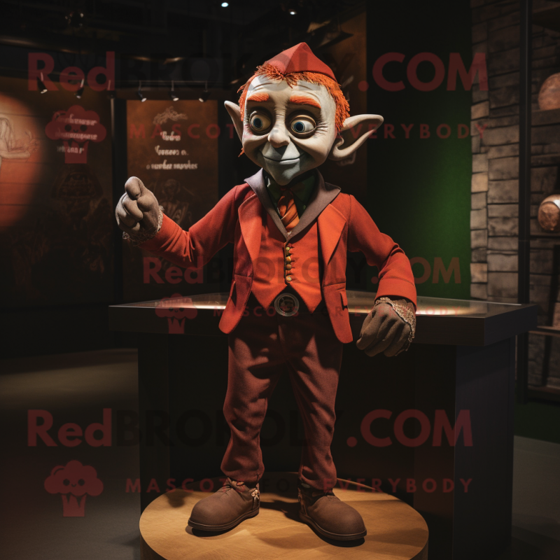 Rust Elf mascot costume character dressed with a Blazer and Lapel pins Rust Elf mascot costume character dressed with a Blazer and Lapel pins