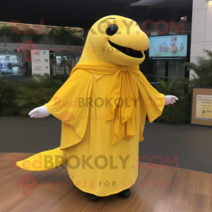 Lemon Yellow Humpback Whale mascot costume character dressed with a Jumpsuit and Shawls