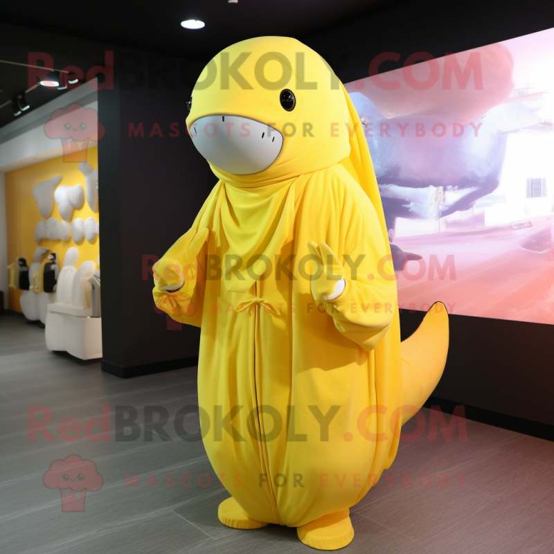 Lemon Yellow Humpback Whale mascot costume character dressed with a Jumpsuit and Shawls