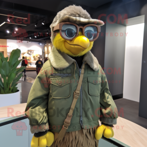 Olive Canary mascot costume character dressed with a Leather Jacket and Eyeglasses