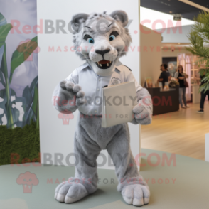 Silver Smilodon mascot costume character dressed with a Poplin Shirt and Clutch bags