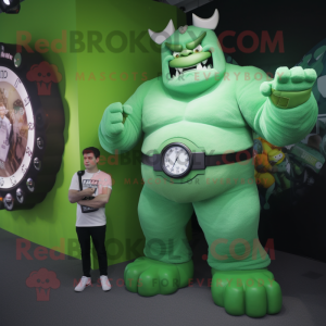 Green Strongman mascot costume character dressed with a Maxi Dress and Smartwatches