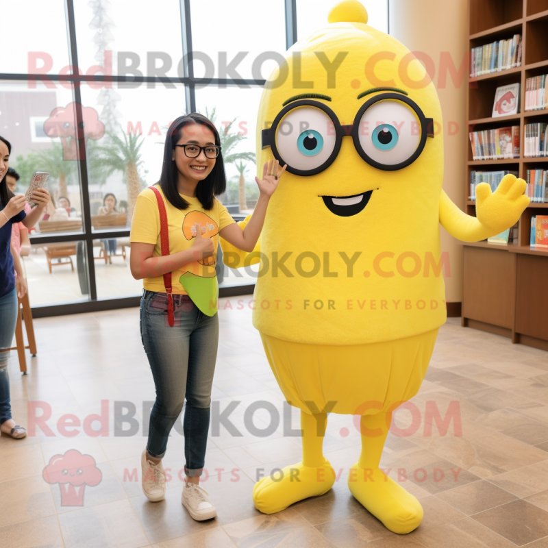 Lemon Yellow Rainbow mascot costume character dressed with a Mom Jeans and Reading glasses Lemon Yellow Rainbow mascot costume character dressed with a Mom Jeans and Reading glasses
