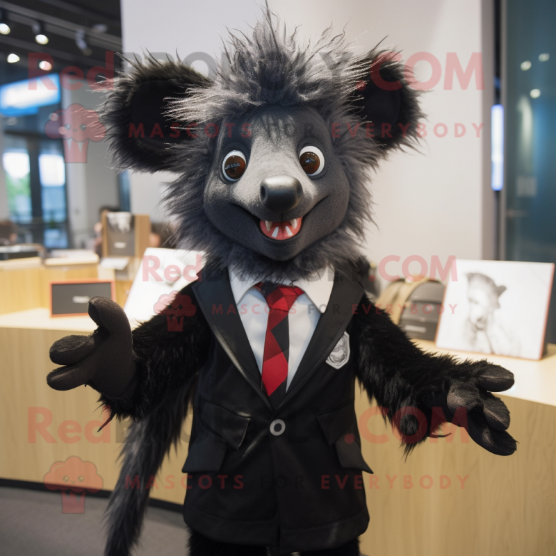 Black Aye-Aye mascot costume character dressed with a Coat and Tie pins