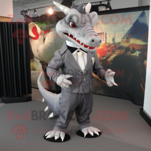 Gray Dragon mascot costume character dressed with a Suit Jacket and Shoe clips