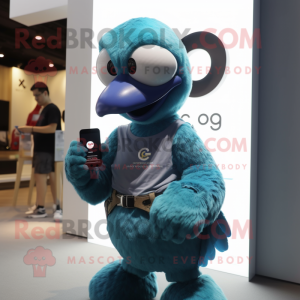 Cyan Dodo Bird mascot costume character dressed with a Graphic Tee and Smartwatches