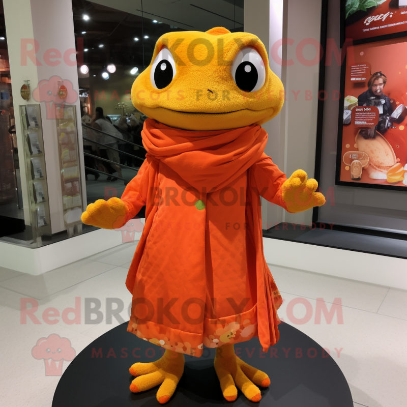 Orange Frog mascot costume character dressed with a Wrap Dress and Shawl pins