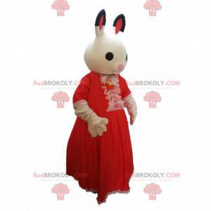 Kaninchenmaskottchen mit einem roten Spitzenkleid. -