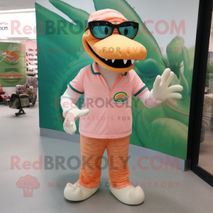 Peach Crocodile mascot costume character dressed with a Graphic Tee and Eyeglasses