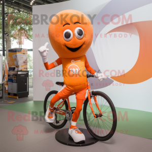 Orange Unicyclist mascot costume character dressed with a Running Shorts and Gloves