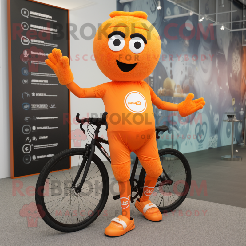 Orange Unicyclist mascot costume character dressed with a Running Shorts and Gloves